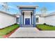 Inviting front entrance with blue pillars, a blue door, and well-maintained landscaping at 19182 Seaview St, Orlando, FL 32833