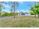 Beautiful single-story house with blue door, gray paint, new roof, and a long gravel driveway at 19182 Seaview St, Orlando, FL 32833