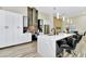 Modern kitchen features an island with seating, white cabinets and stainless steel appliances at 19182 Seaview St, Orlando, FL 32833