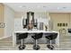 Bright kitchen with a marble waterfall island and sleek black leather bar stools at 19182 Seaview St, Orlando, FL 32833