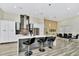 Modern kitchen boasts a waterfall island, sleek countertops, stainless steel appliances, and opens to the dining area at 19182 Seaview St, Orlando, FL 32833