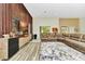 Bright living room featuring wood floors, a modern entertainment center, and neutral toned sectional at 19182 Seaview St, Orlando, FL 32833