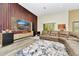 Bright living room featuring wood floors, a modern entertainment center, and neutral toned sectional at 19182 Seaview St, Orlando, FL 32833
