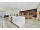 Open floor plan showcasing a kitchen island, dining area, and living room with hardwood floors at 19182 Seaview St, Orlando, FL 32833
