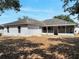 Back of home featuring an enclosed patio and an expansive grassy area at 207 Vervain Ave, Davenport, FL 33837