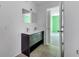 Bright bathroom featuring double sink vanity and neutral tile flooring at 207 Vervain Ave, Davenport, FL 33837