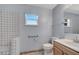 Bathroom featuring a shower with decorative tilework, a window offering natural light, and modern fixtures at 207 Vervain Ave, Davenport, FL 33837