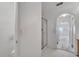 Bathroom with a shower and archway leading to vanity and soaking tub at 207 Vervain Ave, Davenport, FL 33837