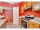Close up of the kitchen featuring wooden cabinets and stainless steel appliances at 207 Vervain Ave, Davenport, FL 33837