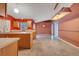 Open kitchen featuring wood cabinets, ample counter space, and tile flooring at 207 Vervain Ave, Davenport, FL 33837