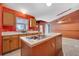 Kitchen view with dual sinks, ample counter space, and wood cabinets at 207 Vervain Ave, Davenport, FL 33837