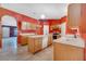 Kitchen view showcasing an island, cabinetry, and updated appliances at 207 Vervain Ave, Davenport, FL 33837
