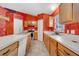 Kitchen featuring wood cabinets, an island, and appliances at 207 Vervain Ave, Davenport, FL 33837