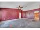 Spacious living room featuring an arched doorway and a ceiling fan at 207 Vervain Ave, Davenport, FL 33837