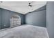 Spacious living room with unique architectural window allowing for tons of natural light at 207 Vervain Ave, Davenport, FL 33837