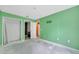 A bright green room featuring a closet, doorway, and bright green walls, creating a unique atmosphere at 207 Vervain Ave, Davenport, FL 33837