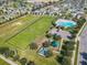 A high-angle shot showcases a community playground, pool, and green spaces, nestled among homes in a Gathering-friendly neighborhood at 209 Citrus Pointe Dr, Haines City, FL 33844