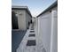 Side yard featuring a white privacy fence, white rock, and pavers at 209 Citrus Pointe Dr, Haines City, FL 33844