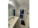 Primary bathroom featuring dual sinks, white cabinets, neutral tile, and glass enclosed shower at 209 Citrus Pointe Dr, Haines City, FL 33844