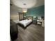 Comfortable bedroom with stylish decor, neutral color palette, and wood-like flooring at 209 Citrus Pointe Dr, Haines City, FL 33844