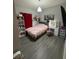 Cozy bedroom featuring light gray walls, light wood-look flooring, a pink comforter, and vanity at 209 Citrus Pointe Dr, Haines City, FL 33844