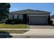 Charming single-story home featuring a well-maintained lawn and a two-car garage at 209 Citrus Pointe Dr, Haines City, FL 33844