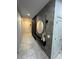 Stylish hallway featuring a decorative wall design, modern lighting, and tile flooring at 209 Citrus Pointe Dr, Haines City, FL 33844