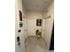 Hallway with multiple doors, neutral decor, and tiled floors at 209 Citrus Pointe Dr, Haines City, FL 33844