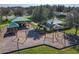 A vibrant playground with swings and picnic areas is shaded by mature trees, offering a fun space for outdoor activities at 209 Citrus Pointe Dr, Haines City, FL 33844