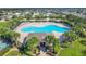 Aerial view of a community pool with palm trees, lounge chairs, and a clubhouse at 209 Citrus Pointe Dr, Haines City, FL 33844