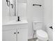 Clean and modern bathroom with a white vanity, sleek black fixtures, and a matching toilet at 227 Sand Ridge Drive, Davenport, FL 33896