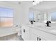 The bathroom has dual sinks, a large mirror, and a shower at 227 Sand Ridge Drive, Davenport, FL 33896