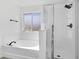 Bathroom features a tub, separate glass enclosed shower and a window at 227 Sand Ridge Drive, Davenport, FL 33896