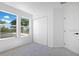 Bedroom with two windows, neutral carpet, and double door closet at 227 Sand Ridge Drive, Davenport, FL 33896