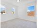 Bright, carpeted bedroom with ample natural light provided by three large windows offering neighborhood views at 227 Sand Ridge Drive, Davenport, FL 33896