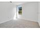 Neutral bedroom boasts carpet flooring and a window that provides natural light at 227 Sand Ridge Drive, Davenport, FL 33896