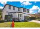 Well-maintained two-story home with nice landscaping and an attached garage at 227 Sand Ridge Drive, Davenport, FL 33896