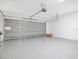 Spacious two-car garage with painted floor, overhead lighting, and ample room for vehicles and storage at 227 Sand Ridge Drive, Davenport, FL 33896
