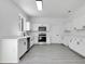 Modern kitchen featuring white cabinetry, stainless steel appliances, and sleek countertops at 227 Sand Ridge Drive, Davenport, FL 33896