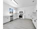 Well-lit kitchen with white cabinets, stainless steel appliances, and an undermount sink at 227 Sand Ridge Drive, Davenport, FL 33896