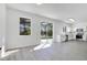 Open-concept kitchen featuring white cabinets, stainless steel appliances, and a sliding glass door to the outside at 227 Sand Ridge Drive, Davenport, FL 33896
