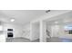 Bright kitchen with white cabinetry, stainless steel appliances, and modern light fixtures at 227 Sand Ridge Drive, Davenport, FL 33896