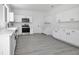 Modern kitchen featuring white cabinets, stainless steel appliances, and sleek countertops at 227 Sand Ridge Drive, Davenport, FL 33896