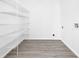 This pantry has wood-look floors and white wire shelving at 227 Sand Ridge Drive, Davenport, FL 33896