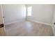Neutral bedroom featuring wood-look floors and a bright window at 2437 Sw 147Th Ln, Ocala, FL 34473