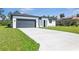 New home featuring a pristine driveway, attached garage and a well manicured lawn at 2437 Sw 147Th Ln, Ocala, FL 34473