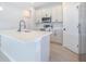 Bright kitchen with quartz countertops, stainless steel appliances, and sleek cabinetry at 2437 Sw 147Th Ln, Ocala, FL 34473