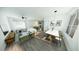 Bright open living space featuring modern decor, dining area, and sleek wood flooring at 2437 Sw 147Th Ln, Ocala, FL 34473