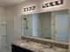 Bathroom featuring double sinks, granite countertops, and modern lighting at 2439 White Lilly Dr, Kissimmee, FL 34747