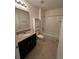 Clean bathroom design with granite counters, tile floors, and a shower-tub combo at 2439 White Lilly Dr, Kissimmee, FL 34747